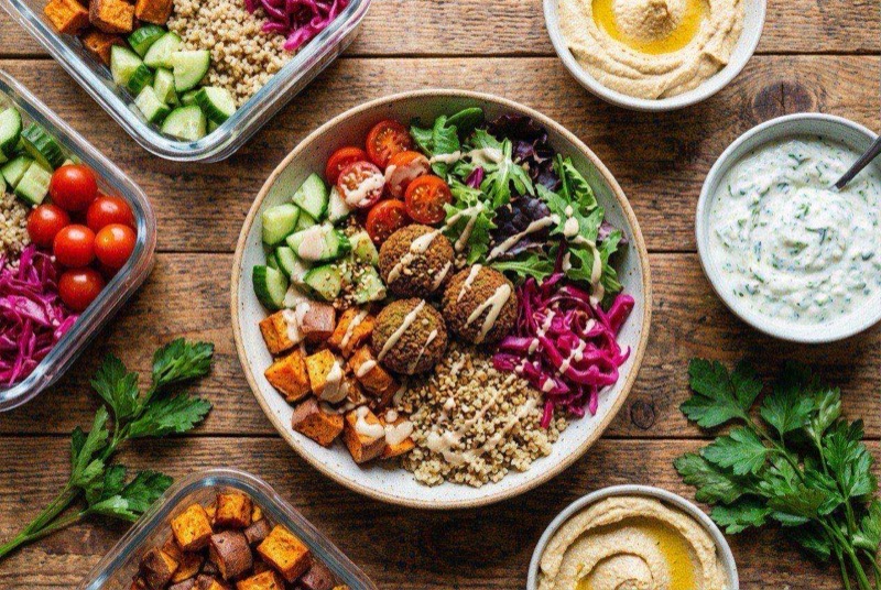 Power bowl with crispy golden falafel, fluffy quinoa, diced cucumber, cherry tomatoes, and drizzled tahini